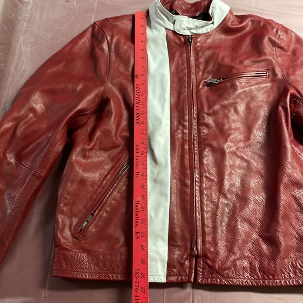 NWT men’s burgundy heavy leather jacket. Very well designed with brass zippers